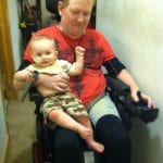 Papa giving Eli a ride on the wheelchair